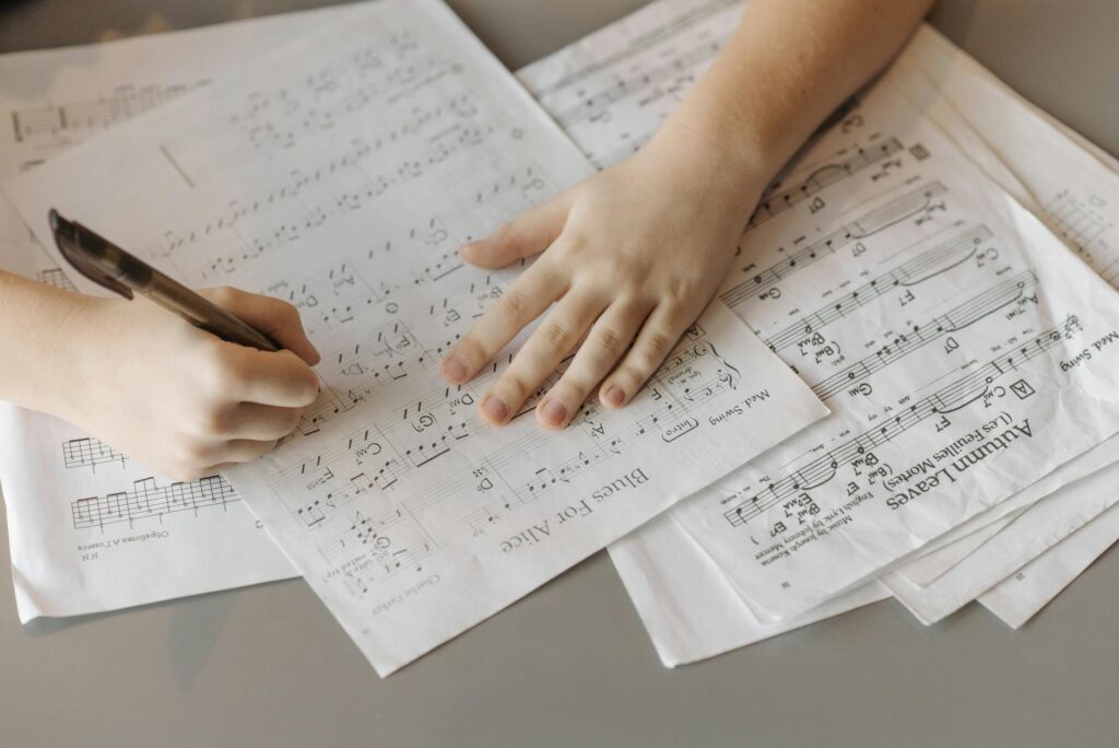person writing notes for a song